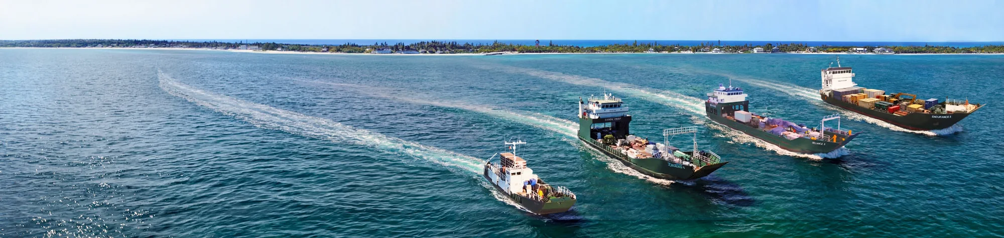 The Bimini Shipping fleet under way in line over turquoise water